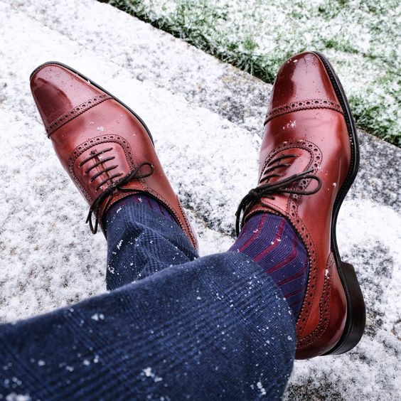 striped dress socks with brown shoes and charcoal suit pants